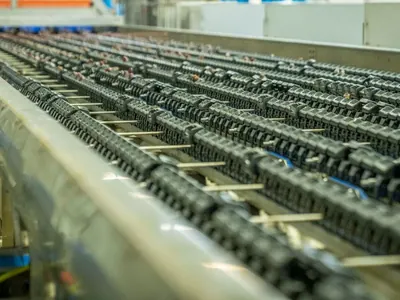Chain conveyor running along a factory production line.